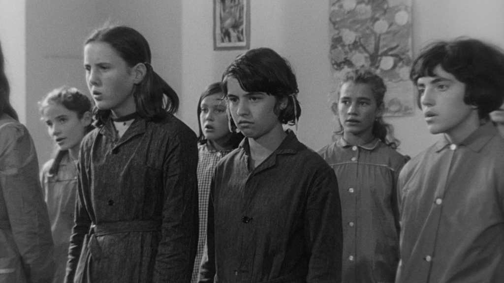 Mouchette (Nadine Nortier) refuses to sing along with her classmates in Robert Bresson's Mouchette (1967).