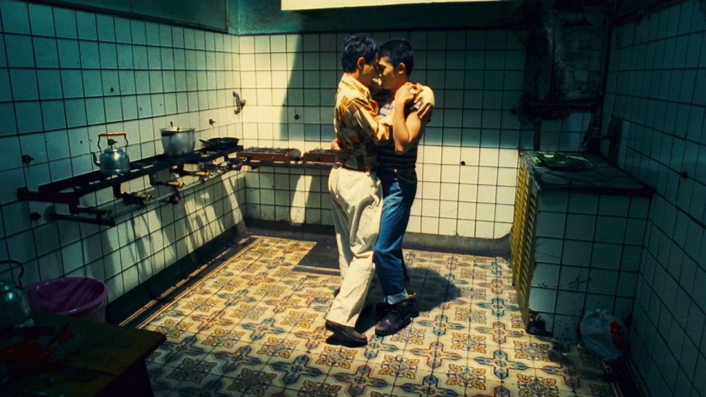 Tony Leung and Leslie Cheung share an intimate dance in a kitchen in the 1997 film Happy Together