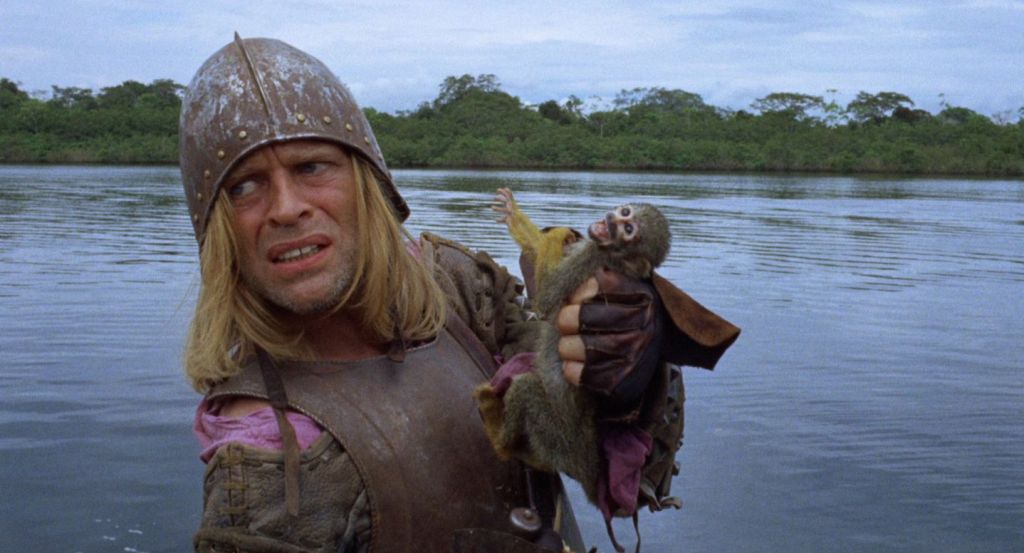 Klaus Kinski as the title character in Aguirre, the Wrath of God, holding a monkey.
