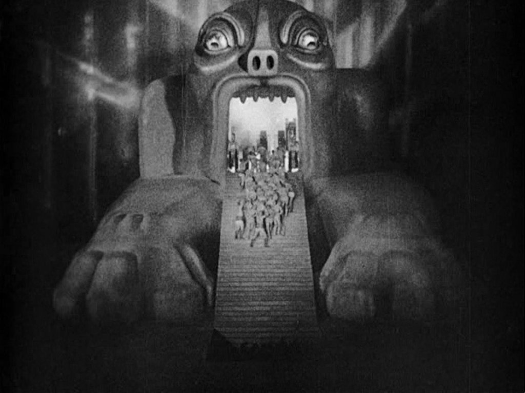 A nightmarish vision of workers being forced into the mouth of Moloch in a scene from Fritz Lang's Metropolis (1927)