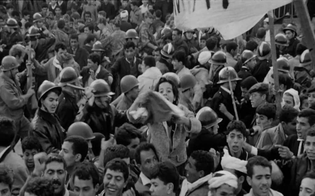 A crowd of protesters in a black-and-white image from The Battle of Algiers (1966).